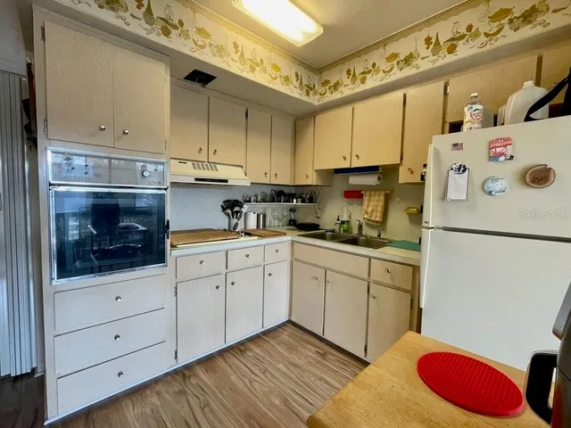 a kitchen with cabinets a washer and dryer