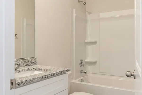 a bathroom with a bathtub and a sink