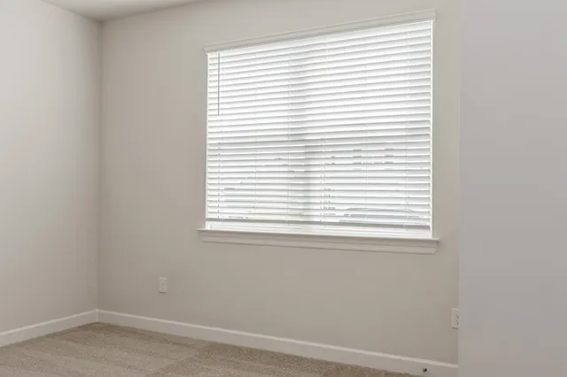 a picture of a bench in front of a window