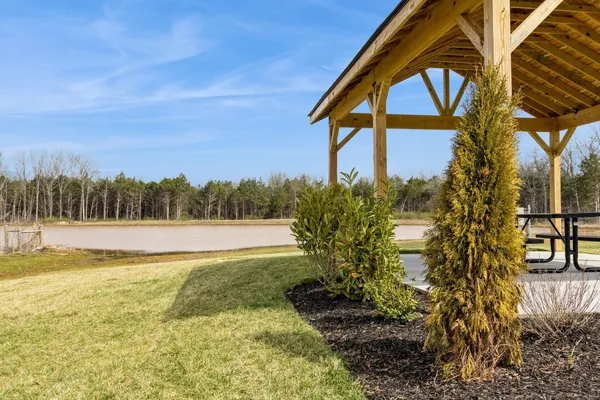 a view of a swimming pool with a patio and a yard