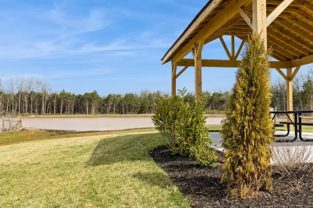 a view of a swimming pool with a patio and a yard