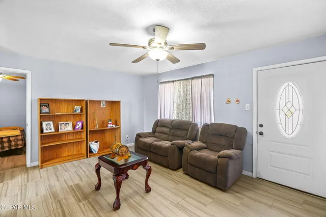 a living room with furniture and wooden floor
