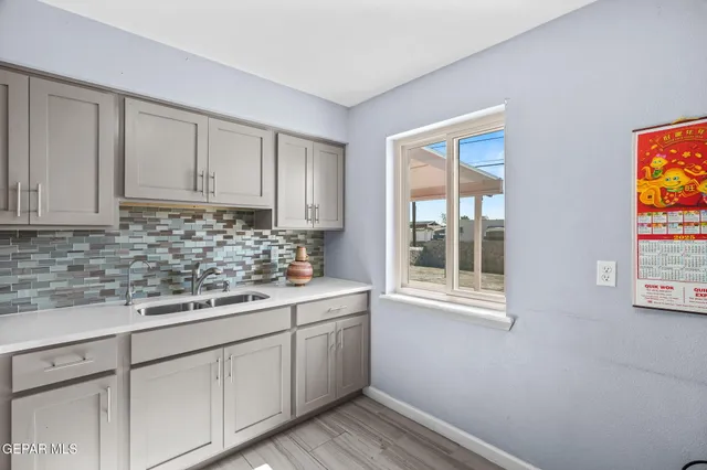 a kitchen with cabinets stainless steel appliances and a sink