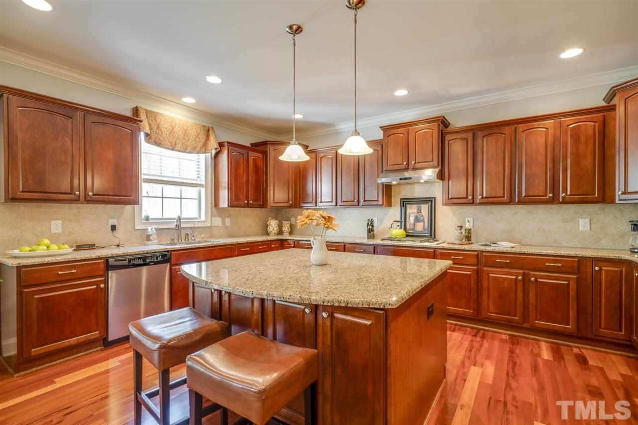 12819 Edsel Drive Raleigh, NC 27613 - Photo 11 of 30 a kitchen with granite countertop a sink a counter space appliances and cabinets