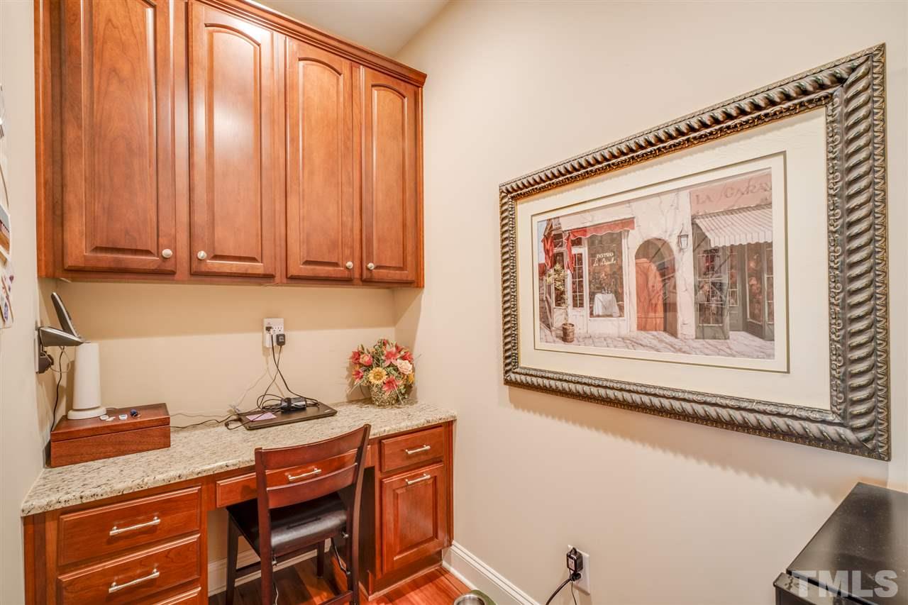 12819 Edsel Drive Raleigh, NC 27613 - Photo 13 of 30 a kitchen with stainless steel appliances granite countertop a refrigerator a stove and a dining table with wooden floor