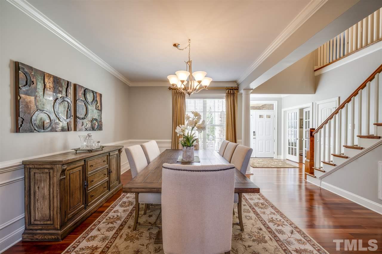 12819 Edsel Drive Raleigh, NC 27613 - Photo 4 of 30 a dining room with wooden floor and large windows