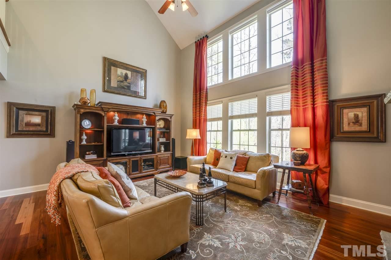 12819 Edsel Drive Raleigh, NC 27613 - Photo 7 of 30 a living room with furniture a flat screen tv and a large window