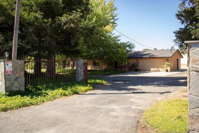 a view of a house with a yard and tree s