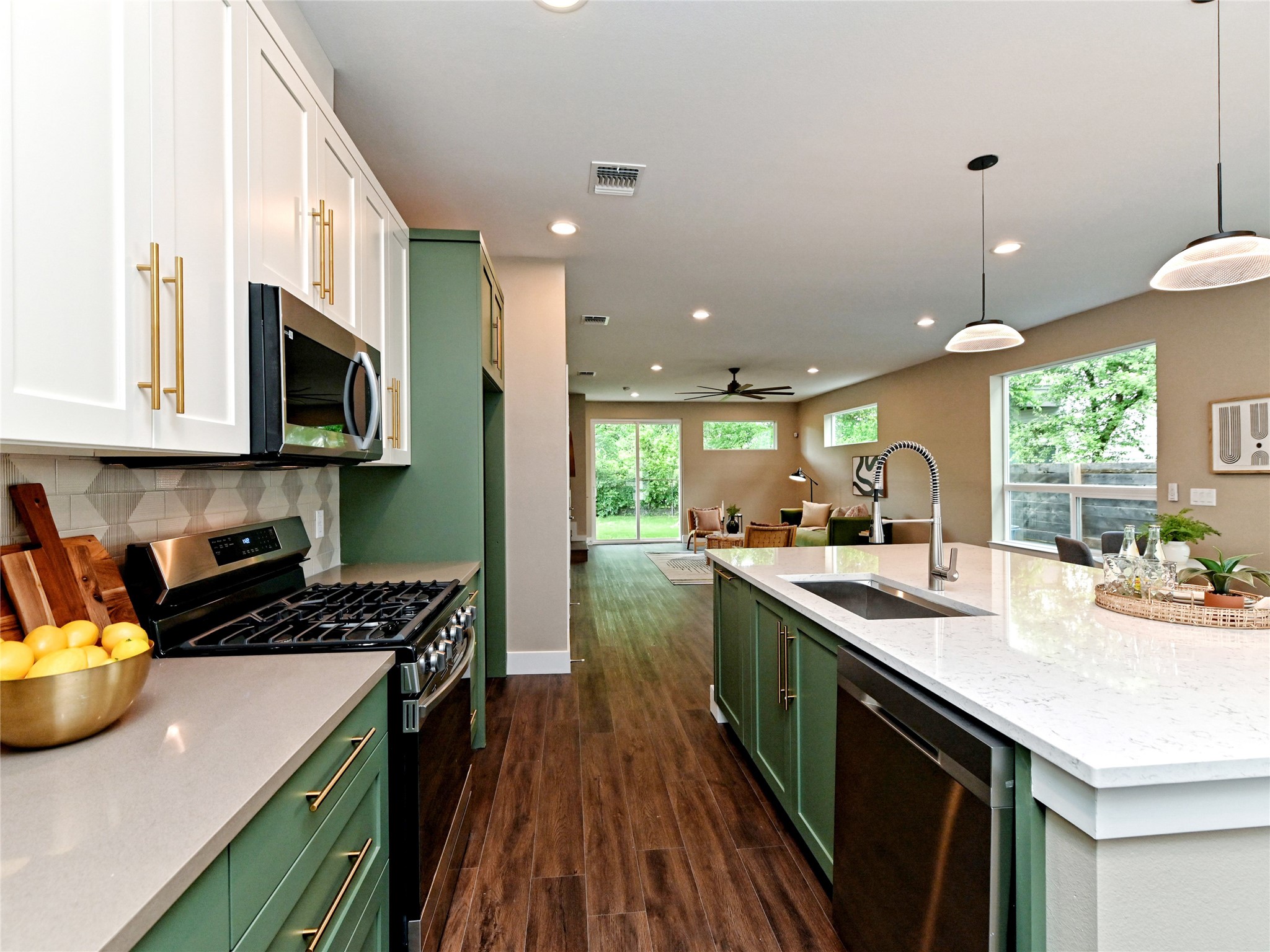 1202 Cometa Street, Unit B Austin, TX 78721 - Photo 11 of 25 a kitchen with a sink a stove and cabinets