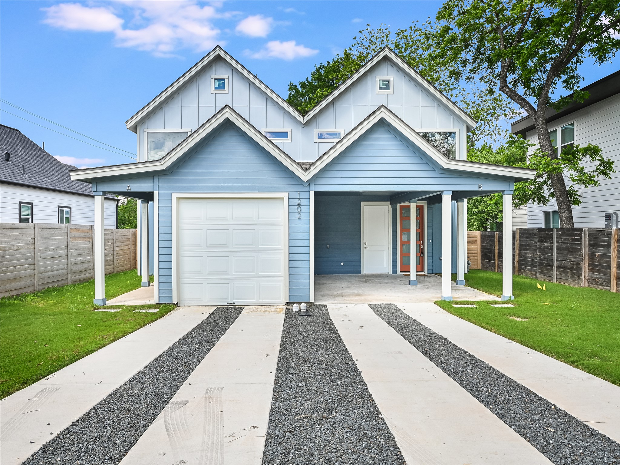 1202 Cometa Street, Unit B Austin, TX 78721 - Photo 2 of 25 a view of a house with a yard and large tree