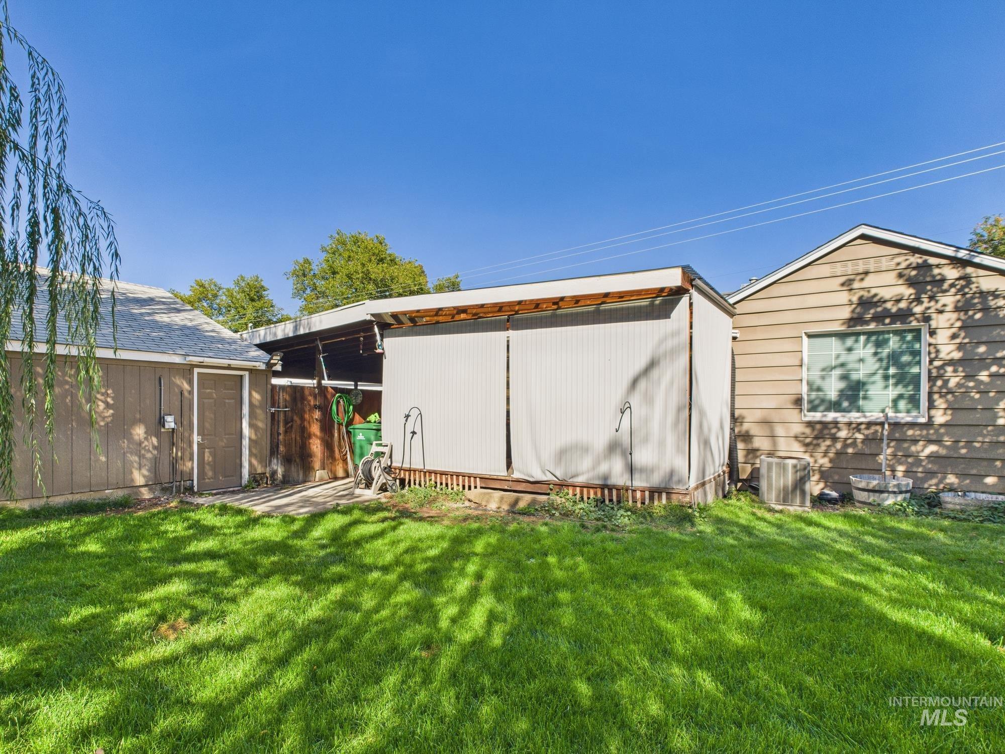 1220 Burrell Avenue Lewiston, ID 83501 - Photo 2 of 28 View of property exterior with a lawn and a shed