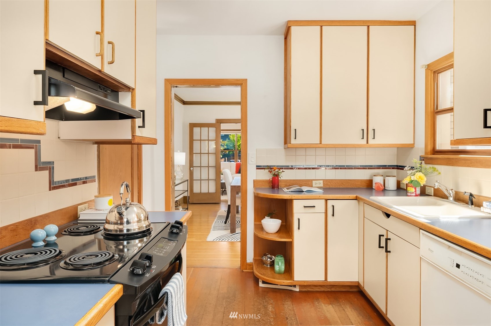 552 North 68th Street Seattle, WA 98103 - Photo 10 of 17 a kitchen with a sink stove and cabinets