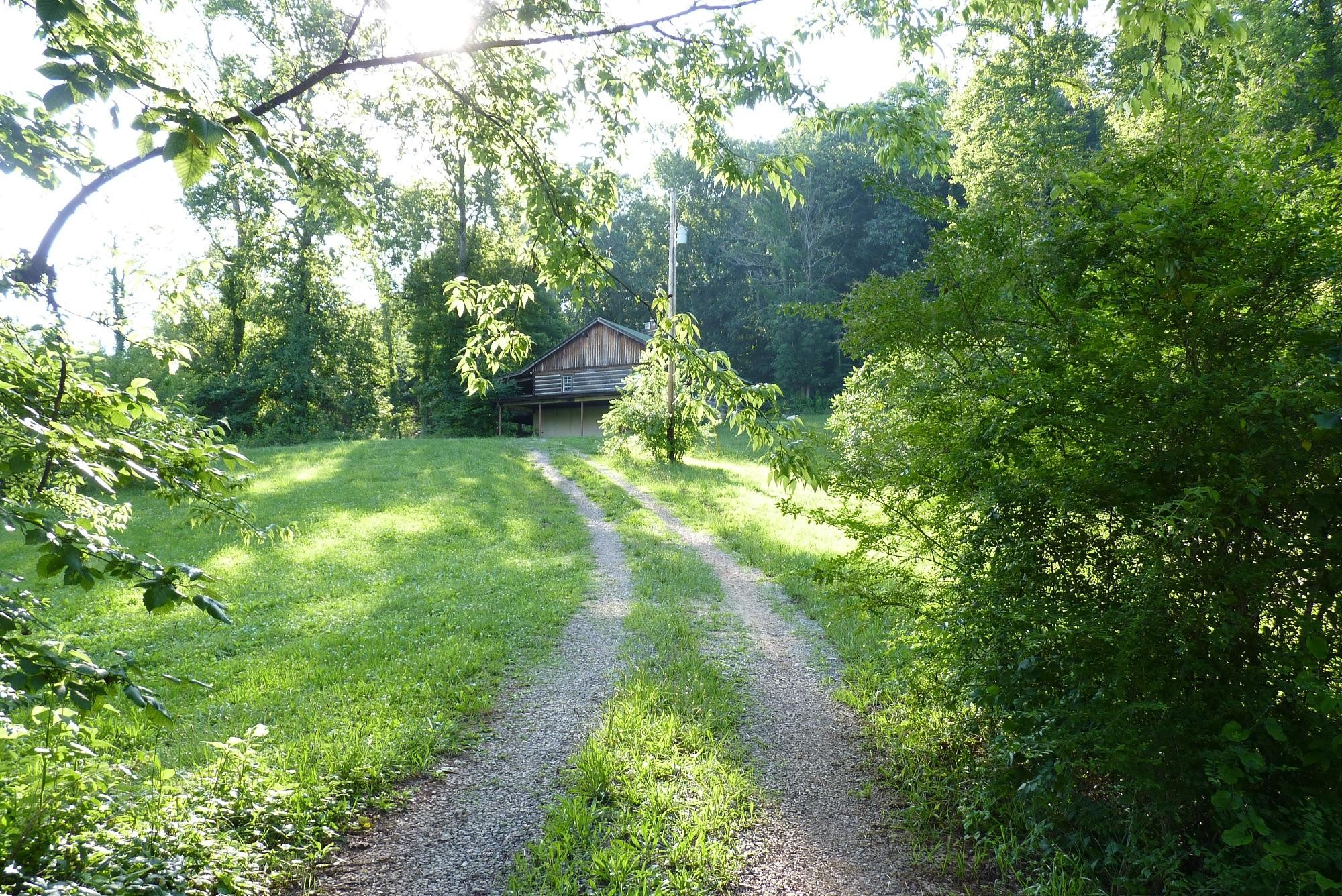 345 Cumberland View Road Clinton, TN 37716 - Photo 2 of 23 a backyard of a house with lots of green space and fountain