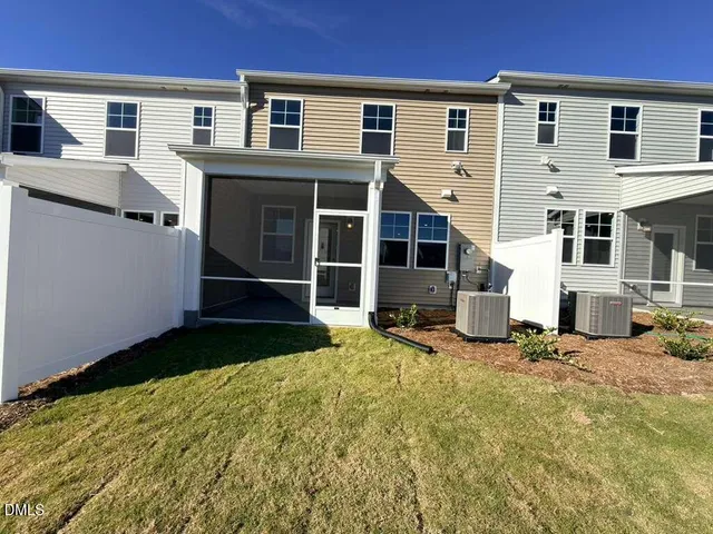 a view of a house with a yard and sitting area