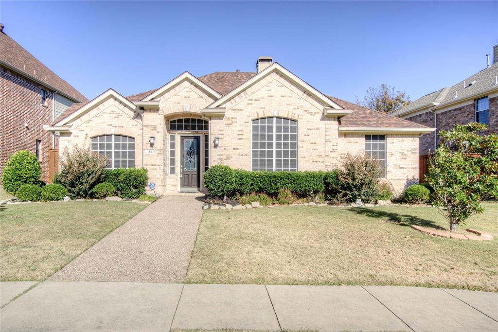 1122 Bridgeway Lane Allen, TX 75013 - Photo 1 of 1 French country inspired facade featuring brick siding, a chimney, a shingled roof, and a front yard