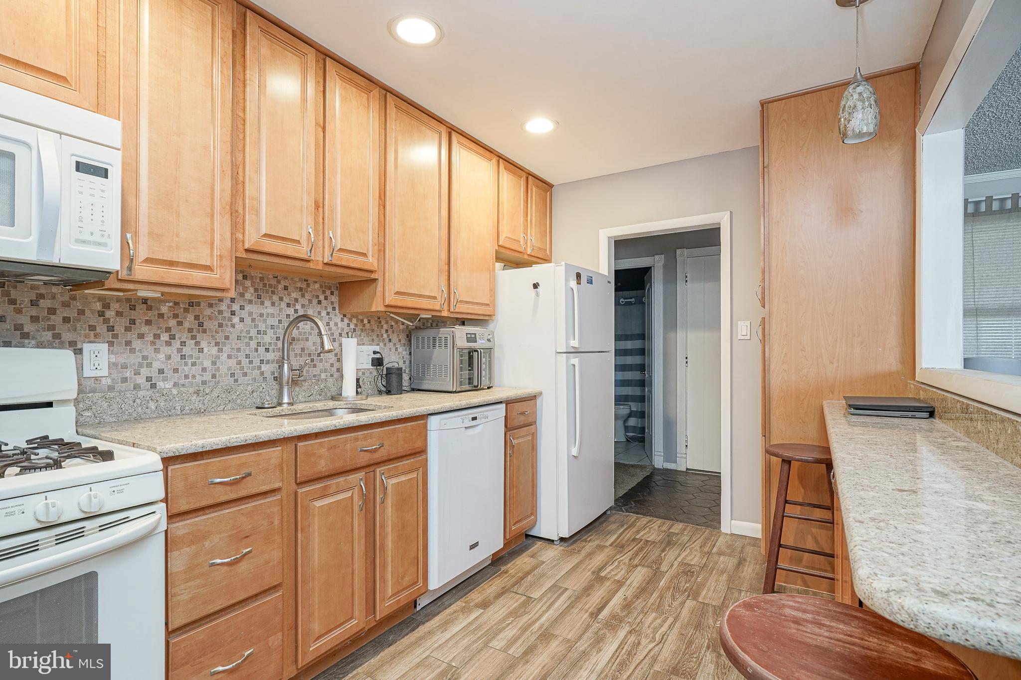 8 Rose Avenue Maple Shade, NJ 08052 - Photo 9 of 26 a kitchen with granite countertop white cabinets and white appliances