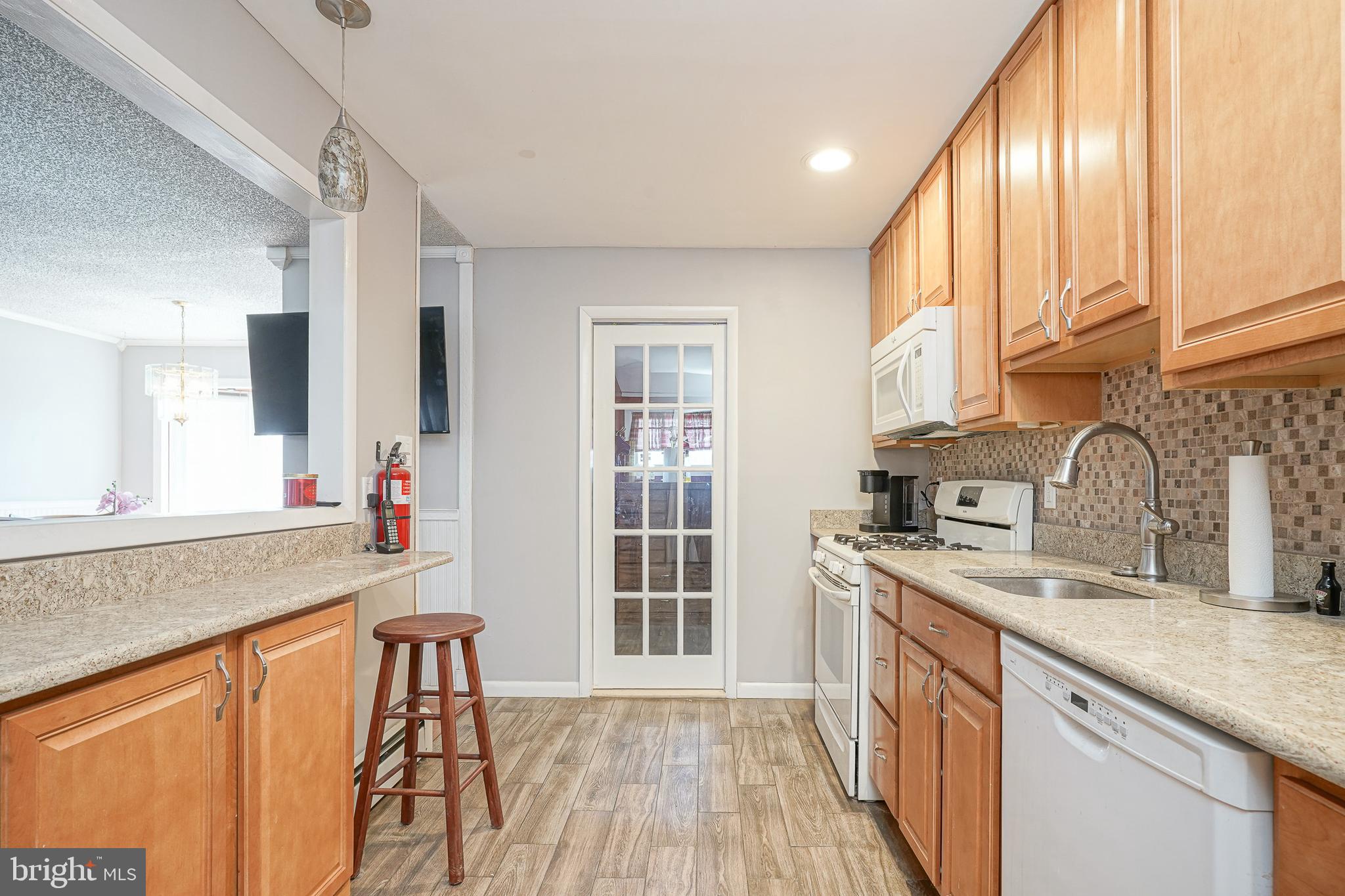 8 Rose Avenue Maple Shade, NJ 08052 - Photo 10 of 26 a kitchen with stainless steel appliances granite countertop a sink stove and cabinets