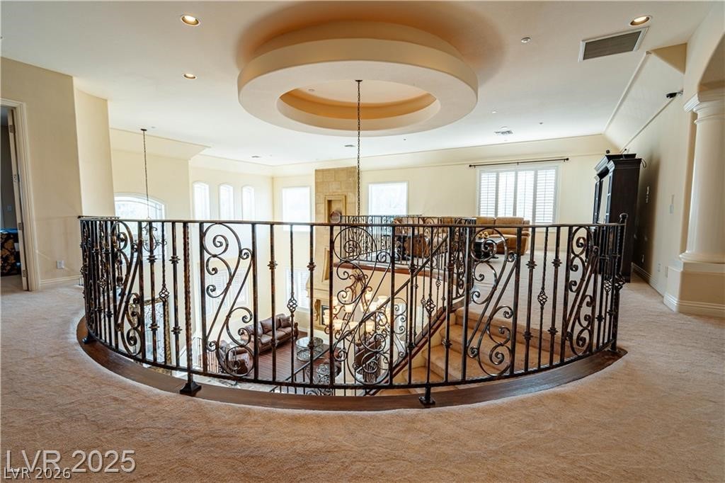 861 Majestic Ridge Court Henderson, NV 89052 - Photo 30 of 68 Hallway with light carpet, an upstairs landing, a tray ceiling, and recessed lighting