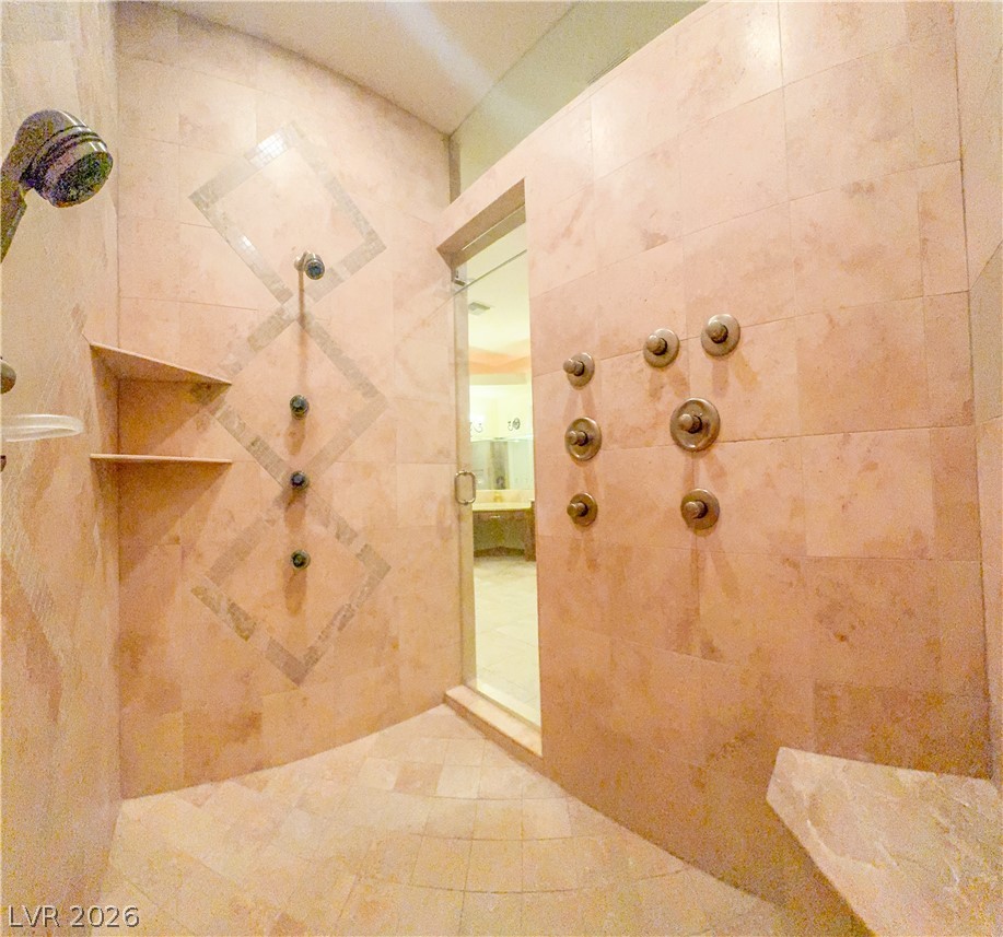 861 Majestic Ridge Court Henderson, NV 89052 - Photo 40 of 68 Full bath featuring a tile shower and tile patterned flooring