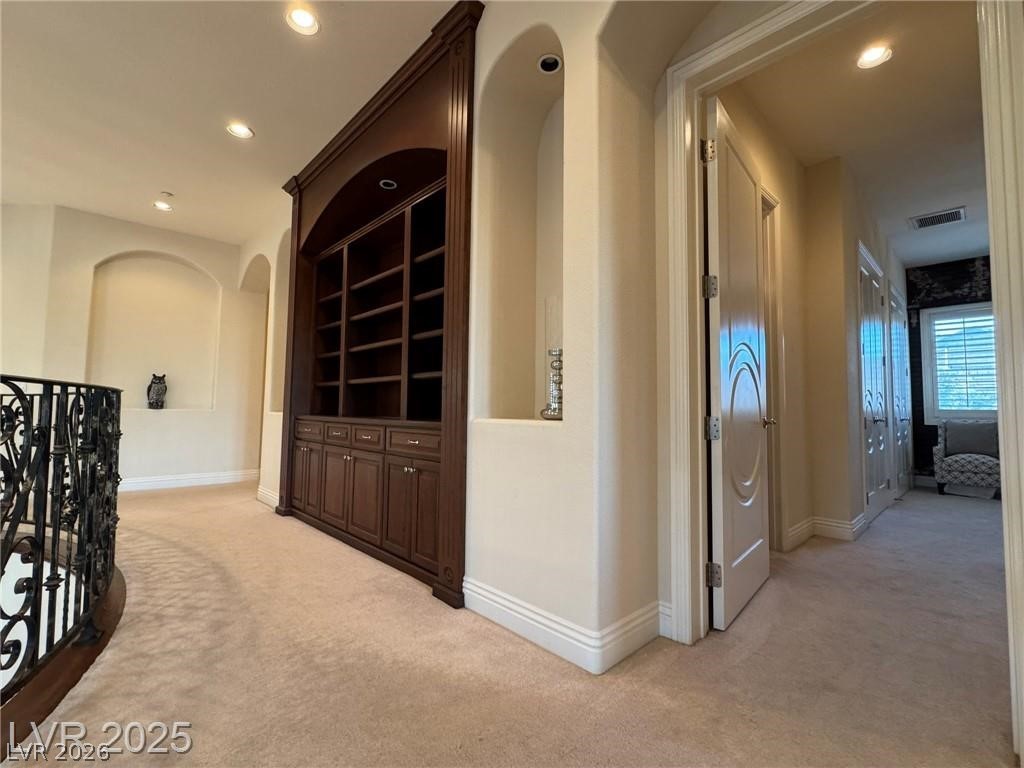 861 Majestic Ridge Court Henderson, NV 89052 - Photo 50 of 68 Corridor with arched walkways, light carpet, recessed lighting, and an upstairs landing