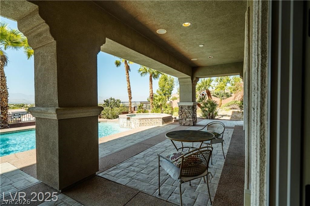 861 Majestic Ridge Court Henderson, NV 89052 - Photo 63 of 68 View of patio featuring a pool with connected hot tub