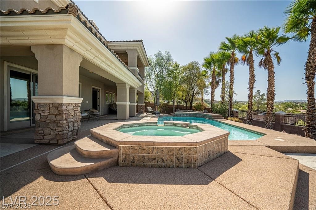 861 Majestic Ridge Court Henderson, NV 89052 - Photo 64 of 68 Relaxing pool / spa with a patio area and a fenced backyard