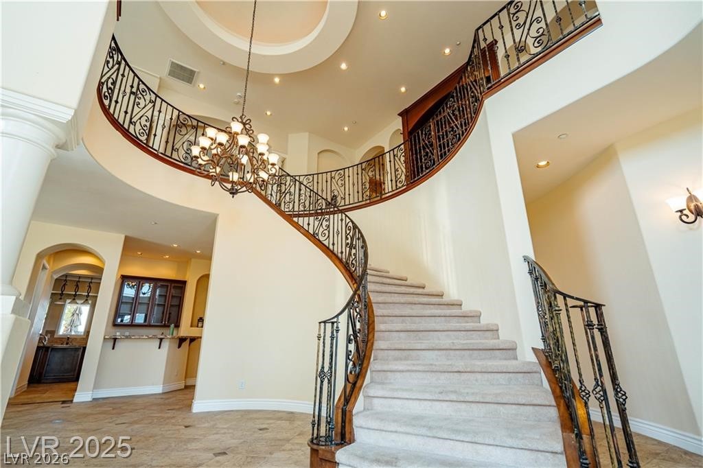 861 Majestic Ridge Court Henderson, NV 89052 - Photo 7 of 68 Stairway with arched walkways and hanging lights