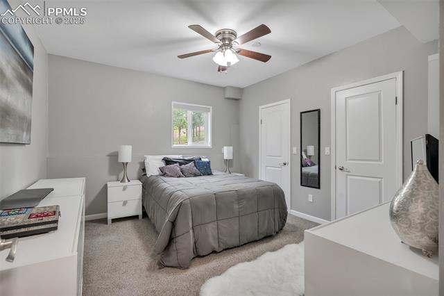615 Cimarron Road Monument, CO 80132 - Photo 39 of 50 Carpeted bedroom with baseboards and ceiling fan