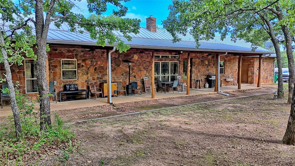 4509 Lazy E Road St. Jo, TX 76265 - Photo 24 of 39 a view of a house with backyard porch and sitting area