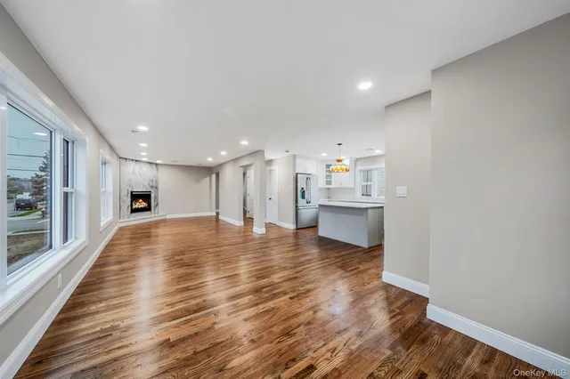 a view of a kitchen with a sink and wooden floor