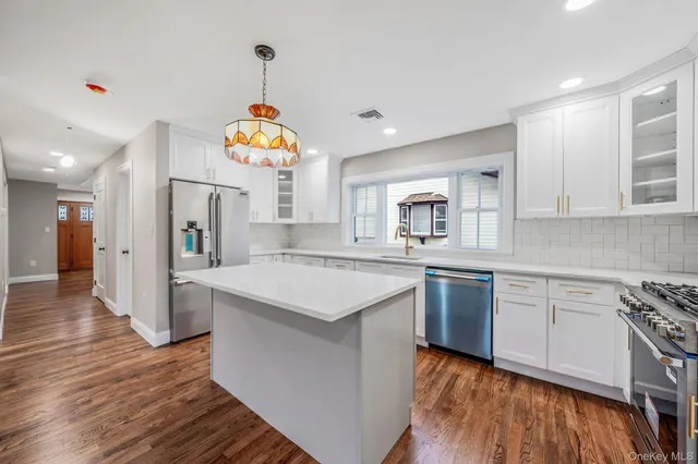 a kitchen with a sink dishwasher a stove and a refrigerator