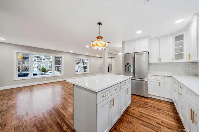 a view of a room with wooden floor and small window