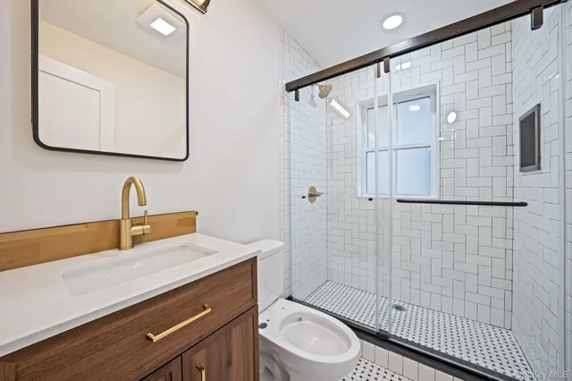 a view of a big room with wooden floor and a ceiling fan