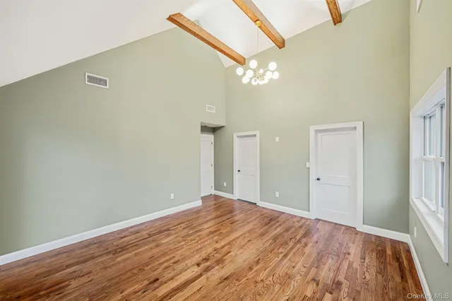 a view of a livingroom with wooden floor and a ceiling fan