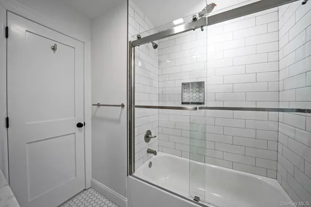 a bathroom with a granite countertop sink a toilet and a mirror