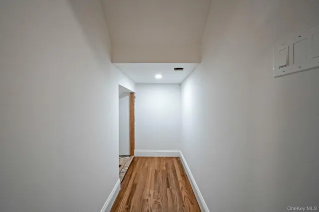 a white toilet sitting next to a white wall