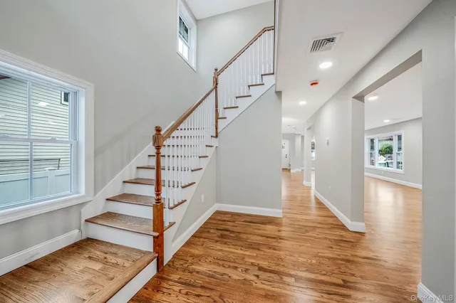 a view of entryway and hall with wooden floor