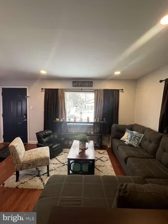 a living room with furniture lamp and window