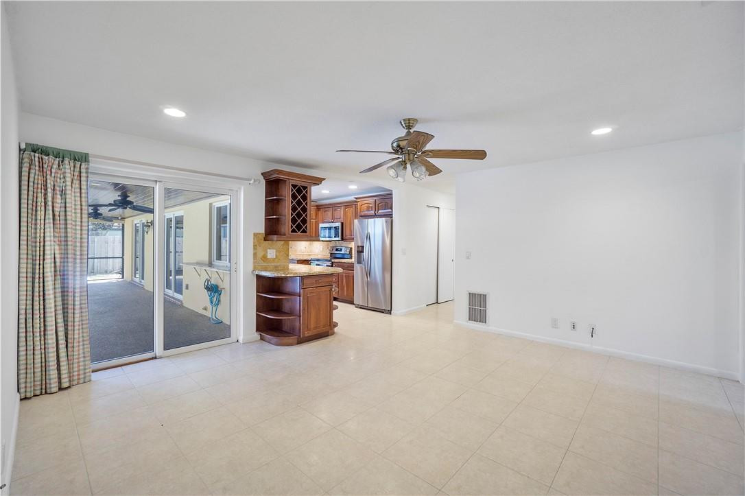 1423 Southwest 14th Street Boca Raton, FL 33486 - Photo 16 of 45 a view of a room with cabinet a ceiling fan and windows