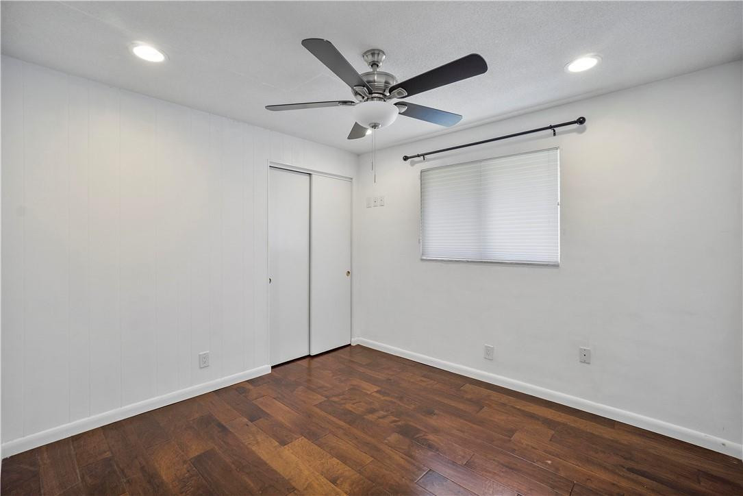 1423 Southwest 14th Street Boca Raton, FL 33486 - Photo 20 of 45 an empty room with wooden floor and ceiling fan