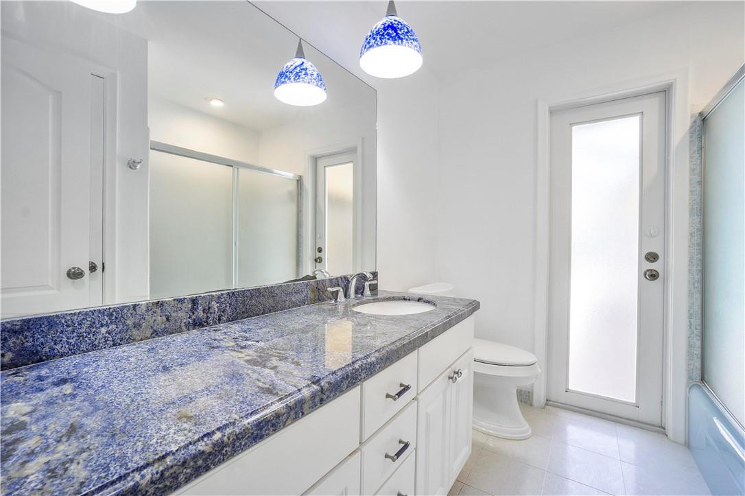1423 Southwest 14th Street Boca Raton, FL 33486 - Photo 22 of 45 a bathroom with a granite countertop sink and a mirror