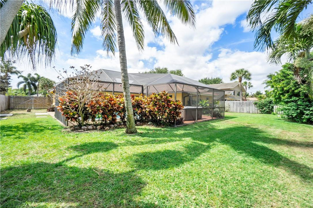 1423 Southwest 14th Street Boca Raton, FL 33486 - Photo 32 of 45 a view of a house with a big yard and palm trees