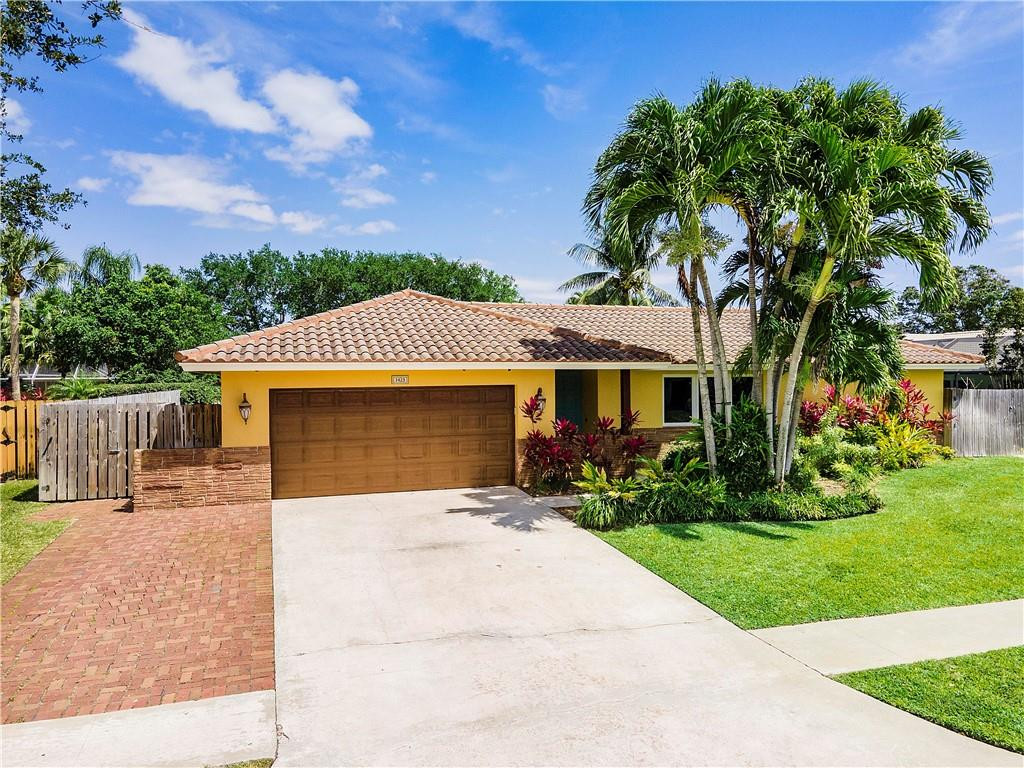 1423 Southwest 14th Street Boca Raton, FL 33486 - Photo 36 of 45 a front view of a house with a garden