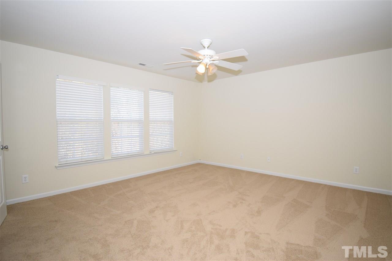 7413 Lagrange Drive Raleigh, NC 27613 - Photo 8 of 12 an empty room with windows and fan