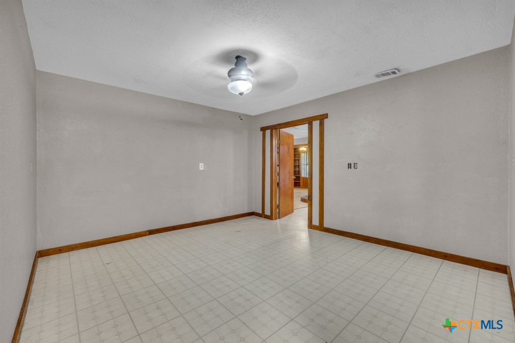 500 Line Camp Loop Spring Branch, TX 78070 - Photo 21 of 48 an empty room with a chandelier fan and windows