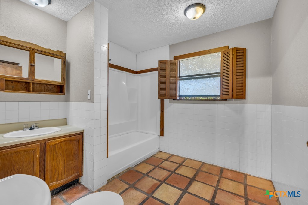 500 Line Camp Loop Spring Branch, TX 78070 - Photo 30 of 48 a bathroom with a sink a mirror and a shower