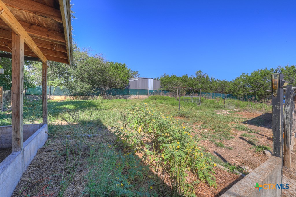 500 Line Camp Loop Spring Branch, TX 78070 - Photo 46 of 48 a view of a yard with plants and a bench