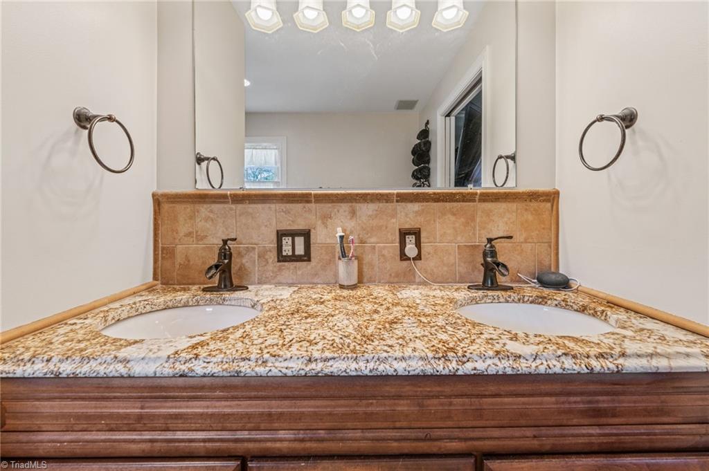 1625 Grooms Road Reidsville, NC 27320 - Photo 25 of 50 Primary en suite features a double sink vanity.