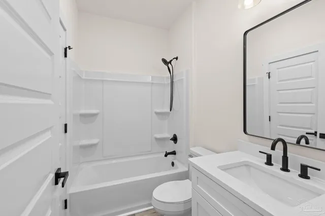 a bedroom with a bed couches chair and a large window