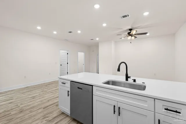 a bathroom with a double vanity sink toilet and shower